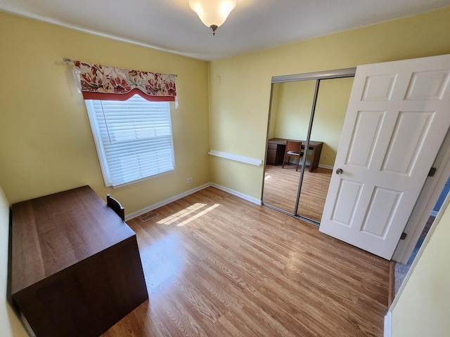 271 E Cleburne Ave, Bartlett, IL 60103 - unfurnished bedroom featuring wood finished floors, a closet, and baseboards