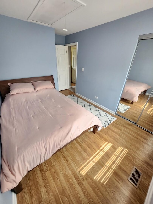 271 E Cleburne Ave, Bartlett, IL 60103 - bedroom featuring attic access, wood finished floors, and baseboards