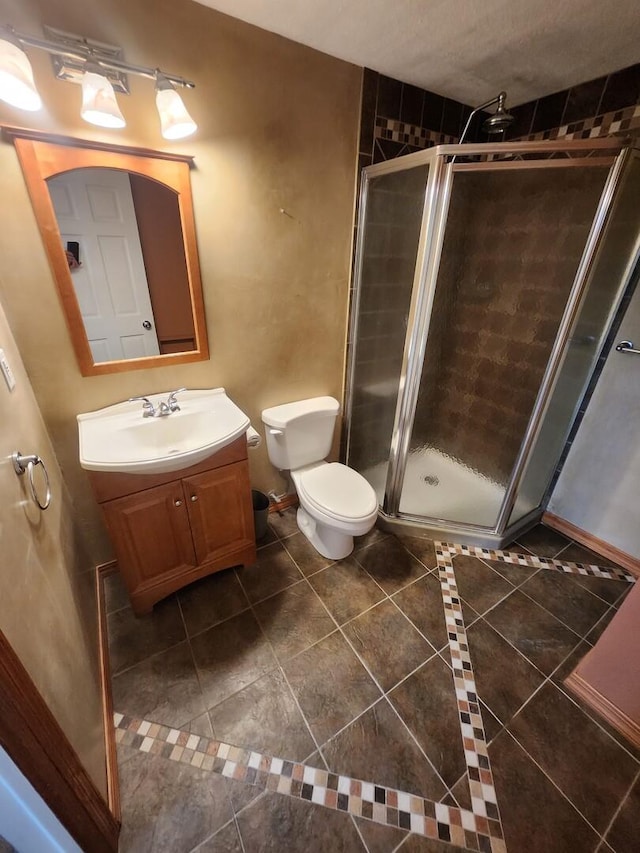 271 E Cleburne Ave, Bartlett, IL 60103 - bathroom featuring vanity, a shower stall, tile patterned flooring, and toilet