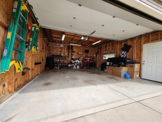 271 E Cleburne Ave, Bartlett, IL 60103 - garage featuring wooden walls and a garage door opener