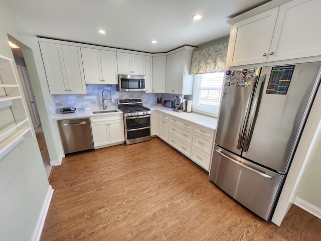 271 E Cleburne Ave, Bartlett, IL 60103 - kitchen with stainless steel appliances, a sink, light countertops, tasteful backsplash, and white cabinetry
