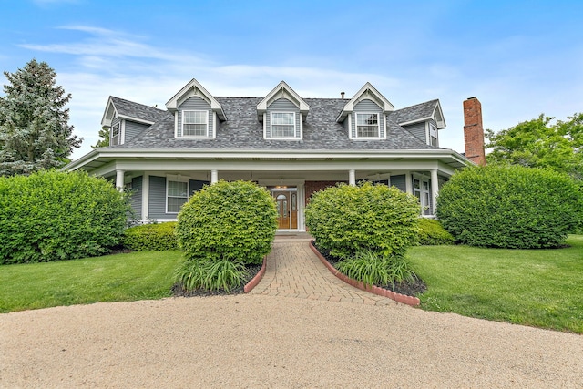 10731 Somonauk Rd, Hinckley, IL 60520 - cape cod-style house with a front yard, roof with shingles, a chimney, and a porch