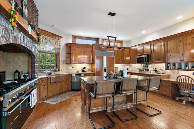 10731 Somonauk Rd, Hinckley, IL 60520 - kitchen featuring high quality appliances, a sink, open shelves, a kitchen island, and tasteful backsplash