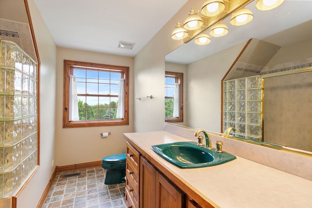 10731 Somonauk Rd, Hinckley, IL 60520 - bathroom with baseboards, toilet, vanity, and a tile shower