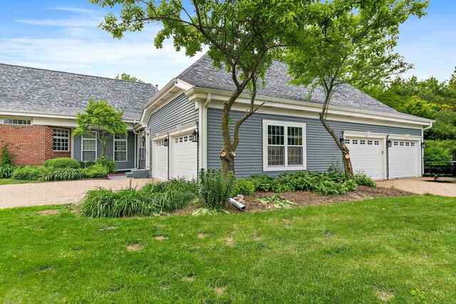 10731 Somonauk Rd, Hinckley, IL 60520 - view of front facade with a garage, driveway, a front lawn, and roof with shingles
