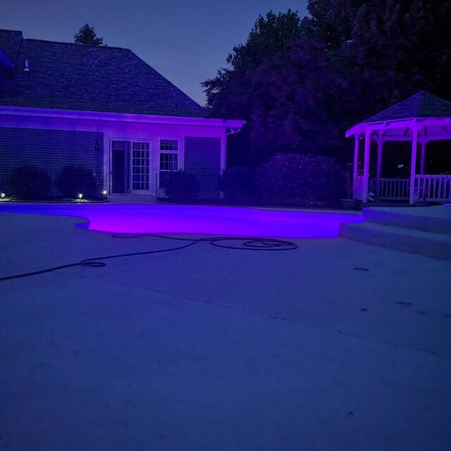 10731 Somonauk Rd, Hinckley, IL 60520 - pool at twilight featuring a gazebo, an outdoor pool, and a patio
