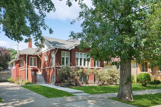 3622 N Avers Ave, Chicago, IL 60618 - view of front of house featuring brick siding, a chimney, roof with shingles, and a front lawn