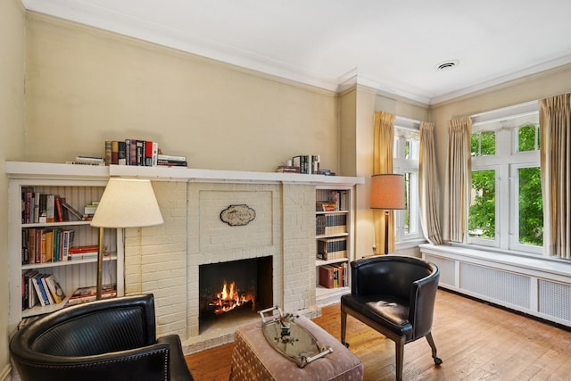 3622 N Avers Ave, Chicago, IL 60618 - living area with wood finished floors, a brick fireplace, ornamental molding, and radiator heating unit