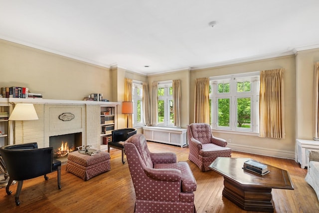 3622 N Avers Ave, Chicago, IL 60618 - living area featuring crown molding, plenty of natural light, a fireplace, wood-type flooring, and radiator heating unit