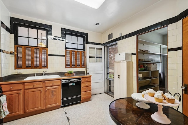 3622 N Avers Ave, Chicago, IL 60618 - kitchen with black dishwasher, a sink, brown cabinets, and tasteful backsplash