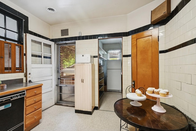 3622 N Avers Ave, Chicago, IL 60618 - kitchen with dishwasher, tile walls, dark countertops, and brown cabinetry