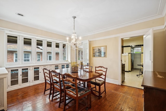3622 N Avers Ave, Chicago, IL 60618 - dining area with a chandelier, dark wood finished floors, baseboards, and crown molding