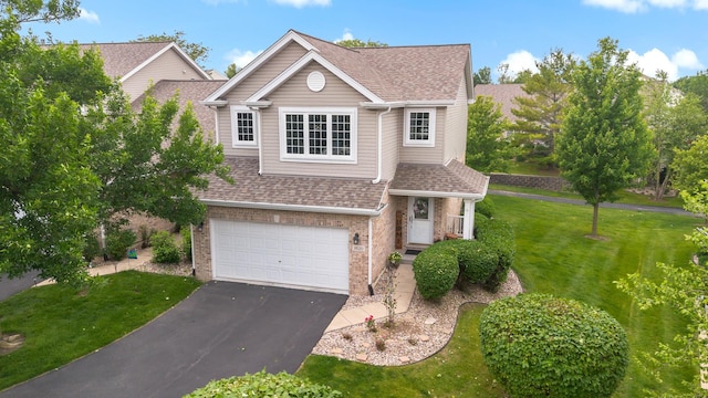 18120 Waterside Cir Unit 18120, Orland Park, IL 60467 - traditional-style home with an attached garage, a shingled roof, asphalt driveway, a front lawn, and brick siding