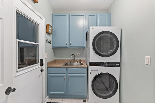18120 Waterside Cir Unit 18120, Orland Park, IL 60467 - laundry area with stacked washing machine and dryer, cabinet space, and light tile patterned flooring