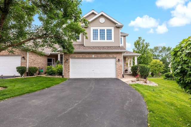 18120 Waterside Cir Unit 18120, Orland Park, IL 60467 - traditional-style house featuring brick siding, asphalt driveway, a front yard, and a garage