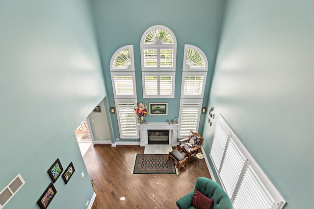 18120 Waterside Cir Unit 18120, Orland Park, IL 60467 - living area featuring a high ceiling, a fireplace, and wood finished floors