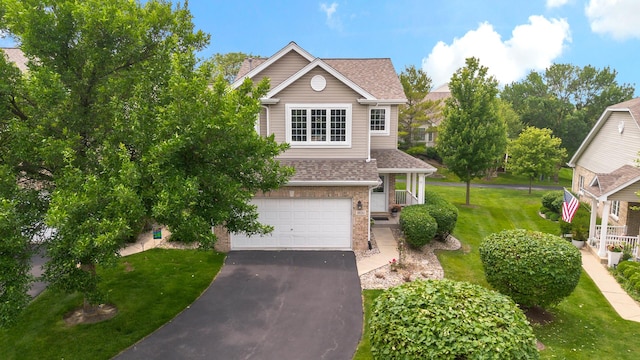 18120 Waterside Cir Unit 18120, Orland Park, IL 60467 - view of front facade with a garage, driveway, a shingled roof, a front yard, and brick siding