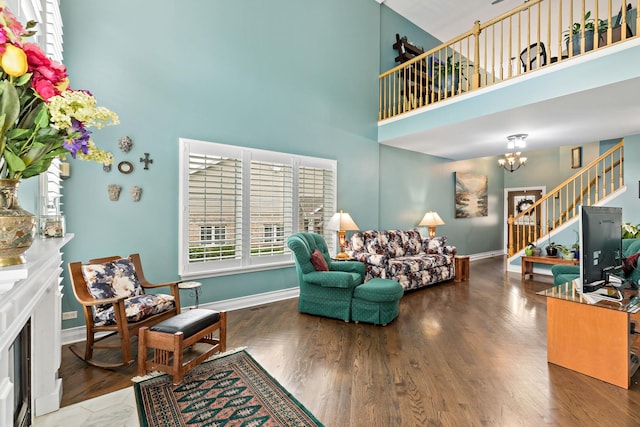 18120 Waterside Cir Unit 18120, Orland Park, IL 60467 - living area featuring a high ceiling, stairway, a chandelier, wood finished floors, and a fireplace with flush hearth