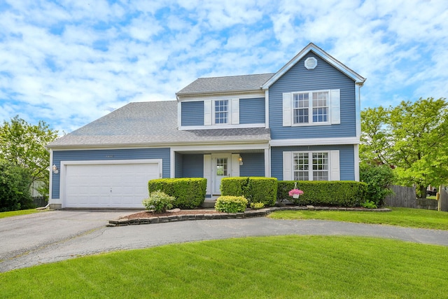 1068 Big Eagle Trl, Carol Stream, IL 60188 - traditional-style house featuring asphalt driveway, an attached garage, and roof with shingles