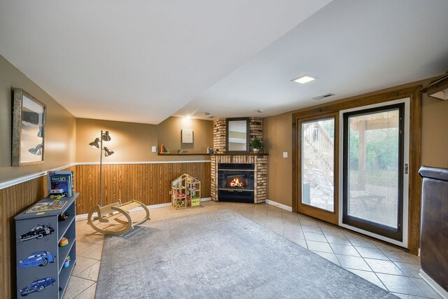 1068 Big Eagle Trl, Carol Stream, IL 60188 - living room with light tile patterned floors, a fireplace, a wainscoted wall, and wooden walls