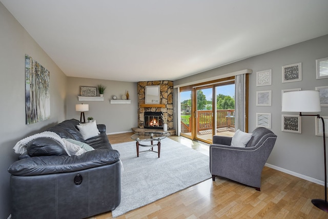 1068 Big Eagle Trl, Carol Stream, IL 60188 - living room featuring light wood-style floors, baseboards, and a stone fireplace