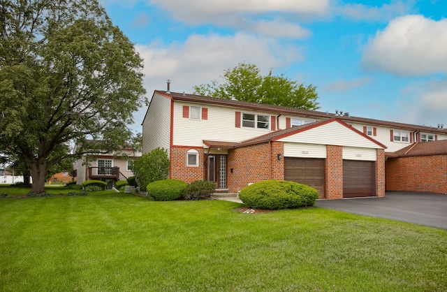 16424 Oxford Dr, Tinley Park, IL 60477 - view of front facade with an attached garage, a front lawn, asphalt driveway, and brick siding