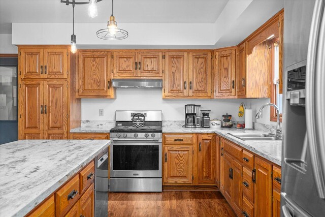 4461 N Il State Route 23, Leland, IL 60531 - kitchen with appliances with stainless steel finishes, a sink, under cabinet range hood, dark wood-style flooring, and brown cabinetry