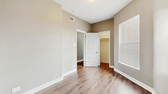 6347 S Drexel Ave, Chicago, IL 60637 - unfurnished bedroom featuring wood finished floors, baseboards, a closet, and a spacious closet