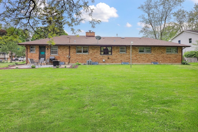 1320 Adeline Ct, Aurora, IL 60505 - rear view of property featuring a patio, brick siding, a chimney, a lawn, and cooling unit