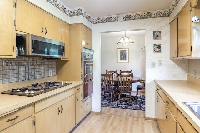 1320 Adeline Ct, Aurora, IL 60505 - kitchen featuring appliances with stainless steel finishes, light wood-style flooring, light countertops, and a warming drawer