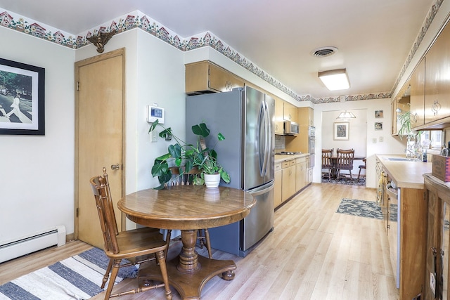 1320 Adeline Ct, Aurora, IL 60505 - kitchen with stainless steel appliances, light countertops, baseboard heating, and light wood finished floors