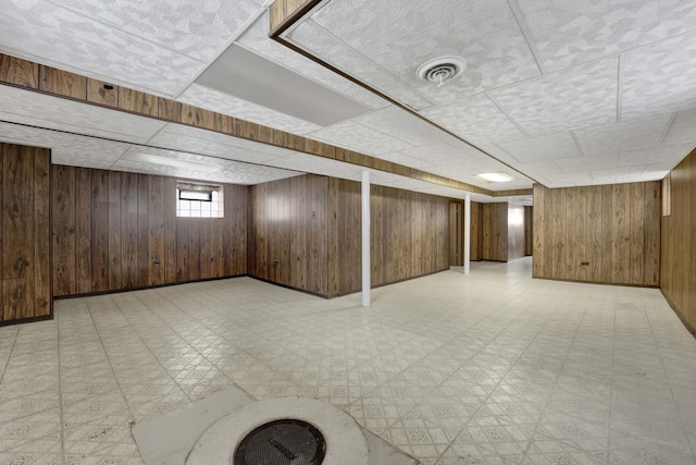 5548 S Kedvale Ave, Chicago, IL 60629 - basement featuring light floors, wooden walls, a drop ceiling, and baseboards