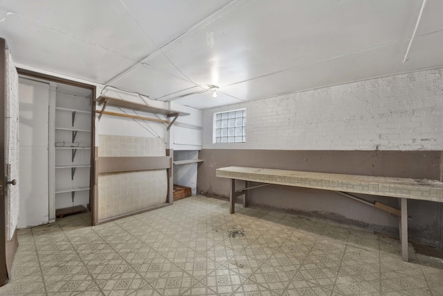 5548 S Kedvale Ave, Chicago, IL 60629 - below grade area with tile patterned floors and brick wall
