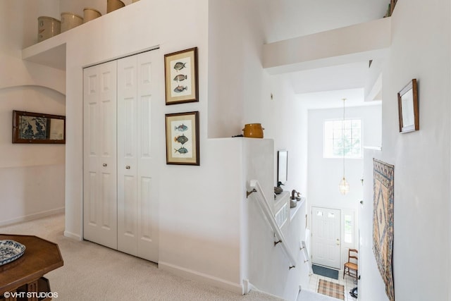 645 Concord Way Unit 645, Prospect Heights, IL 60070 - hallway featuring baseboards, a high ceiling, carpet flooring, and a chandelier