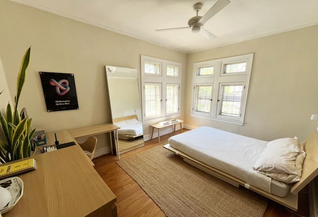 208 N Oak Park Ave Unit 3Jj, Oak Park, IL 60302 - bedroom featuring crown molding, wood finished floors, a ceiling fan, and baseboards