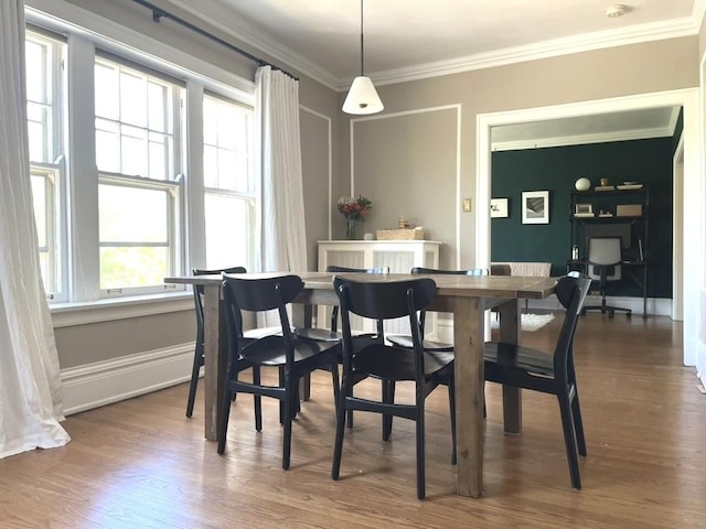 208 N Oak Park Ave Unit 3Jj, Oak Park, IL 60302 - dining space featuring plenty of natural light, ornamental molding, dark wood-style floors, and baseboards