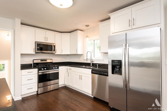 5700 Grange Ave, Oak Forest, IL 60452 - kitchen with appliances with stainless steel finishes, a sink, dark countertops, dark wood-style floors, and white cabinetry