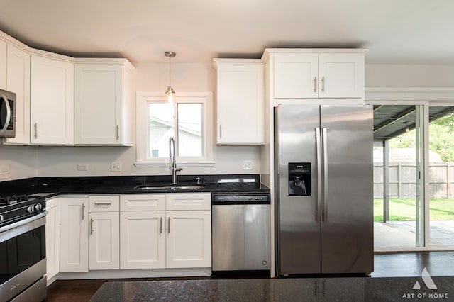 5700 Grange Ave, Oak Forest, IL 60452 - kitchen featuring appliances with stainless steel finishes, a sink, white cabinets, dark countertops, and decorative light fixtures