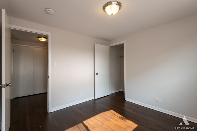 5700 Grange Ave, Oak Forest, IL 60452 - unfurnished bedroom with dark wood-style flooring, baseboards, and a closet