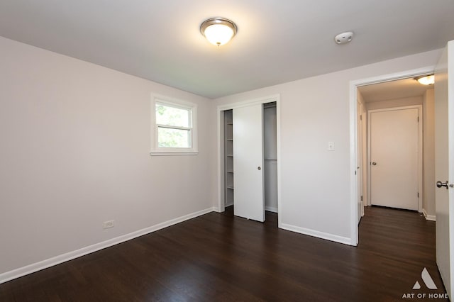 5700 Grange Ave, Oak Forest, IL 60452 - unfurnished bedroom with dark wood-style floors, baseboards, and a closet