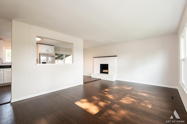 5700 Grange Ave, Oak Forest, IL 60452 - unfurnished living room with dark wood-style floors, plenty of natural light, and baseboards