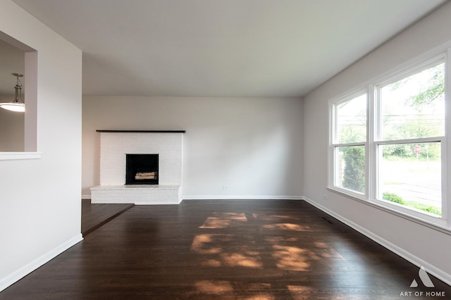 5700 Grange Ave, Oak Forest, IL 60452 - unfurnished living room featuring healthy amount of natural light, dark wood finished floors, and a fireplace