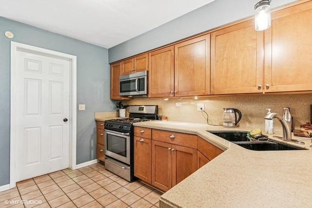 1063 Ridgefield Cir, Carol Stream, IL 60188 - kitchen featuring appliances with stainless steel finishes, a sink, light countertops, decorative backsplash, and light tile patterned floors