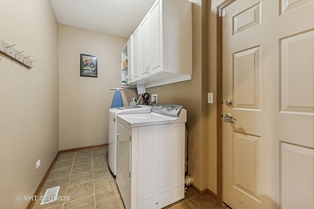 825 Colchester Dr, Oswego, IL 60543 - laundry room with independent washer and dryer, cabinet space, light tile patterned flooring, and baseboards