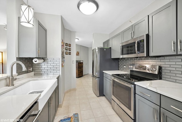 222 N Columbus Dr Unit 2408, Chicago, IL 60601 - kitchen featuring stainless steel appliances, gray cabinets, a sink, and tasteful backsplash