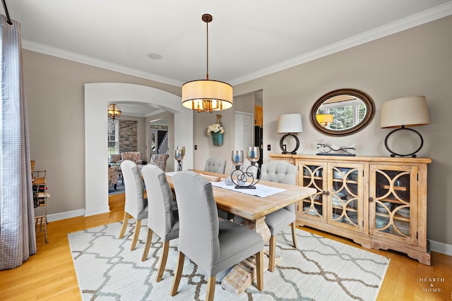 605 Birch Ln, Fox River Grove, IL 60021 - dining area featuring arched walkways, crown molding, a chandelier, light wood-style flooring, and baseboards