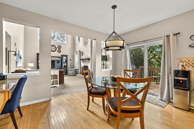 605 Birch Ln, Fox River Grove, IL 60021 - dining space featuring light wood-style floors, a fireplace, and baseboards