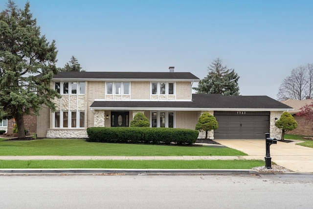 7723 W 157th St, Orland Park, IL 60462 - view of front of house featuring an attached garage, concrete driveway, a front lawn, and brick siding
