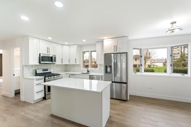 7723 W 157th St, Orland Park, IL 60462 - kitchen with appliances with stainless steel finishes, backsplash, light wood-type flooring, white cabinets, and recessed lighting