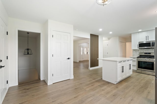 7723 W 157th St, Orland Park, IL 60462 - kitchen featuring appliances with stainless steel finishes, light wood-style flooring, light countertops, recessed lighting, and white cabinetry